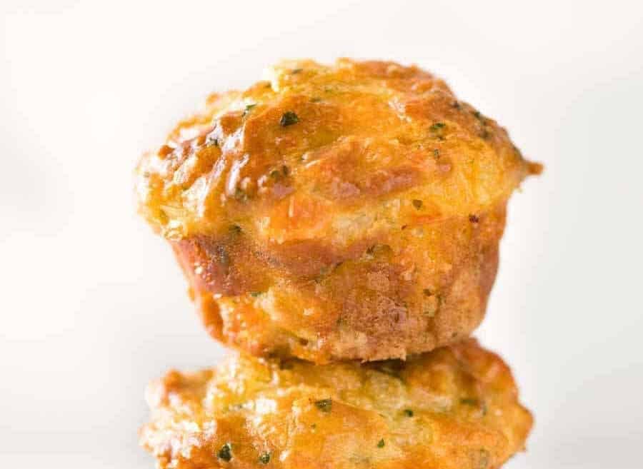 Foto gruesa de un muffin de queso salado con una cúpula dorada.