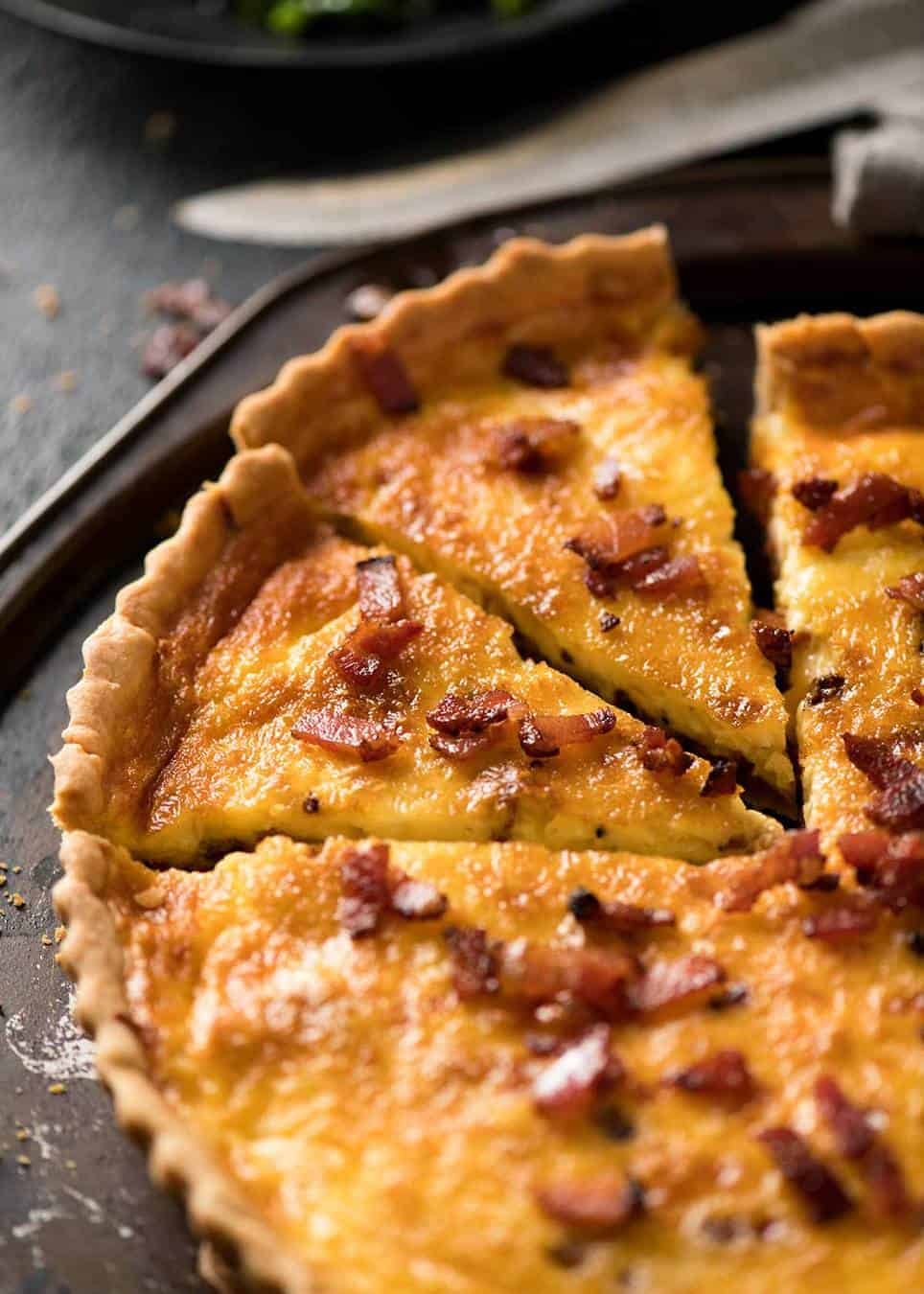 Foto de quiche lorraine en una bandeja rústica de metal para servir